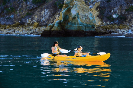 a women and a child kayaking in the waters of little habor campground catalina island